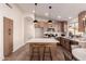 Modern kitchen with stainless appliances, island with seating, and wooden cabinets at 1627 W Maplewood St, Chandler, AZ 85286