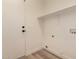 A simple laundry room with a door, shelf, and connections for a washer and dryer at 1627 W Maplewood St, Chandler, AZ 85286