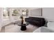 Bright living room featuring a modern sofa, neutral chairs, a dark wood table, and large windows at 1627 W Maplewood St, Chandler, AZ 85286