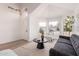 Bright living room featuring a modern sofa, neutral chairs, a dark wood table, and large windows at 1627 W Maplewood St, Chandler, AZ 85286