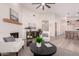 Spacious living room featuring a fireplace, modern furniture, and an open layout leading to the kitchen at 1627 W Maplewood St, Chandler, AZ 85286