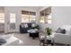 Cozy living room with a gray sofa, white chairs, dark wood tables and white walls at 1627 W Maplewood St, Chandler, AZ 85286