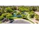 Aerial view of winding path leading to serene pond with wooden bridge and meticulously landscaped grounds at 1925 W Olive Way, Chandler, AZ 85248