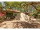 Charming backyard oasis with mature trees, lush landscaping, and private area for outdoor enjoyment at 1925 W Olive Way, Chandler, AZ 85248