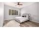 Bedroom with new floors, ceiling fan, and a large window at 1925 W Olive Way, Chandler, AZ 85248