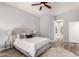 Bedroom features a large bed, ceiling fan, and ensuite bathroom with a shower at 1925 W Olive Way, Chandler, AZ 85248