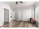 This bedroom features wood floors, a ceiling fan and a closet with sliding doors at 1925 W Olive Way, Chandler, AZ 85248