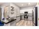 Modern kitchen with stainless steel appliances, sleek granite countertops, and stylish floating shelves at 1925 W Olive Way, Chandler, AZ 85248