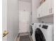 This laundry room features white cabinets and a new washer and dryer at 1925 W Olive Way, Chandler, AZ 85248