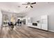 Spacious living room, with a modern fireplace, open to the kitchen and dining area, featuring wood flooring at 1925 W Olive Way, Chandler, AZ 85248