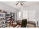 Home office features a dark desk, built-in shelving, and a ceiling fan at 1925 W Olive Way, Chandler, AZ 85248