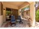 The patio features a pair of blue chairs and a side table with a patterned rug at 1925 W Olive Way, Chandler, AZ 85248