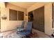 The patio features a pair of blue chairs and a side table with a patterned rug at 1925 W Olive Way, Chandler, AZ 85248
