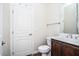 Clean bathroom with a single sink vanity, toilet, and framed mirror at 20750 N 87 St # 2103, Scottsdale, AZ 85255