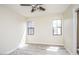 Bright, open bedroom with two windows, a ceiling fan and wood-look flooring at 20750 N 87 St # 2103, Scottsdale, AZ 85255