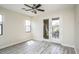 Bright bedroom with a ceiling fan, wood-style floors, and a balcony access at 20750 N 87 St # 2103, Scottsdale, AZ 85255