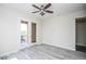 Bright bedroom featuring a ceiling fan, balcony access, and wood-look floors at 20750 N 87 St # 2103, Scottsdale, AZ 85255