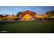 Beautifully lit community building at twilight with well-manicured lawn and desert landscape at 20750 N 87 St # 2103, Scottsdale, AZ 85255