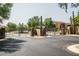 Gated community entrance with stone pillars, desert landscaping, and well maintained asphalt at 20750 N 87 St # 2103, Scottsdale, AZ 85255