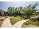 Well-maintained community green space with manicured landscaping, walkways, trees, and various seating areas at 20750 N 87 St # 2103, Scottsdale, AZ 85255