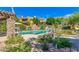Beautiful community pool area with a pergola, lush landscaping, and comfortable seating for residents' enjoyment at 20750 N 87 St # 2103, Scottsdale, AZ 85255