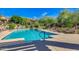 Resort-style community pool with ample lounge seating, umbrellas, and manicured landscaping at 20750 N 87 St # 2103, Scottsdale, AZ 85255