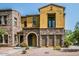 Attractive two-story townhouse with stone accents, an arched entryway, and a small balcony at 20750 N 87 St # 2103, Scottsdale, AZ 85255