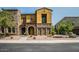 Inviting exterior of a two-story home with a stone facade, multiple windows, and well-maintained landscaping at 20750 N 87 St # 2103, Scottsdale, AZ 85255