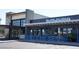 Modern commercial building with large windows, a blue decorative fence, and clear signage for 'Pure Sushi' restaurant at 20750 N 87 St # 2103, Scottsdale, AZ 85255