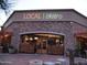 Charming bistro with a stone facade, large windows, and an inviting entrance adorned with stacked firewood for a rustic touch at 20750 N 87 St # 2103, Scottsdale, AZ 85255