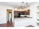 Bright kitchen with wooden floors, black appliances, and an open counter to the living area at 20750 N 87 St # 2103, Scottsdale, AZ 85255