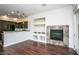Open living area with wooden floors, a modern fireplace, and an open layout to the kitchen at 20750 N 87 St # 2103, Scottsdale, AZ 85255