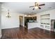 Spacious living area with hardwood floors, an open layout, and kitchen view at 20750 N 87 St # 2103, Scottsdale, AZ 85255