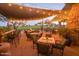 Relaxing outdoor patio with comfortable seating, fire pit and views of the golf course under a shaded awning with string lights at 20750 N 87 St # 2103, Scottsdale, AZ 85255
