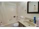 Bathroom showcasing a shower-tub combo with white shower curtain and a brown vanity at 22222 W Lower Buckeye Rd, Buckeye, AZ 85326