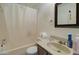 Bathroom showcasing a shower-tub combo with white shower curtain and a brown vanity at 22222 W Lower Buckeye Rd, Buckeye, AZ 85326