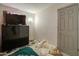 This is a bedroom with a large television, a lamp, and a partially made bed at 22222 W Lower Buckeye Rd, Buckeye, AZ 85326