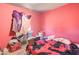 A bedroom featuring a bed with a blanket, a window with curtains, and various storage containers at 22222 W Lower Buckeye Rd, Buckeye, AZ 85326