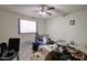 This is a bedroom with a ceiling fan and a large window that provides natural light at 22222 W Lower Buckeye Rd, Buckeye, AZ 85326