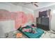 This is a bedroom featuring a bed, a large television, and a partially painted wall at 22222 W Lower Buckeye Rd, Buckeye, AZ 85326