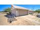 Home exterior showing the tan garage door, electrical wires overhead, and a large dirt lot at 22222 W Lower Buckeye Rd, Buckeye, AZ 85326