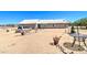Single story home with a light colored roof and stucco walls, on a large dirt lot with car parked out front at 22222 W Lower Buckeye Rd, Buckeye, AZ 85326