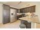 Kitchen features stainless steel appliances, dark cabinets, laminate countertops, and tile flooring at 22222 W Lower Buckeye Rd, Buckeye, AZ 85326