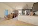 Open floor plan view to the kitchen with tile floors, sofa, dark cabinets, a stainless refrigerator at 22222 W Lower Buckeye Rd, Buckeye, AZ 85326