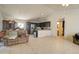 Open floor plan living room with tile floors, a sofa, dark cabinets, and a view of the bathroom at 22222 W Lower Buckeye Rd, Buckeye, AZ 85326