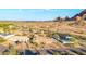 This aerial view shows a home surrounded by desert landscaping with mountain views and a blue sky at 2319 N 58Th St, Scottsdale, AZ 85257