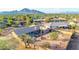 A captivating aerial shot captures a charming single-story home with desert landscaping with mountain views in the distance at 2319 N 58Th St, Scottsdale, AZ 85257