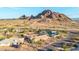 A stunning aerial shot captures a home set against a backdrop of desert and mountains with a nearby pool at 2319 N 58Th St, Scottsdale, AZ 85257