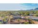 This is an aerial view of a single-story home with desert landscaping surrounded by mountains in the background at 2319 N 58Th St, Scottsdale, AZ 85257