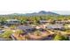 An aerial view shows a charming single-story home with a tile roof, desert landscaping, and mountain views at 2319 N 58Th St, Scottsdale, AZ 85257